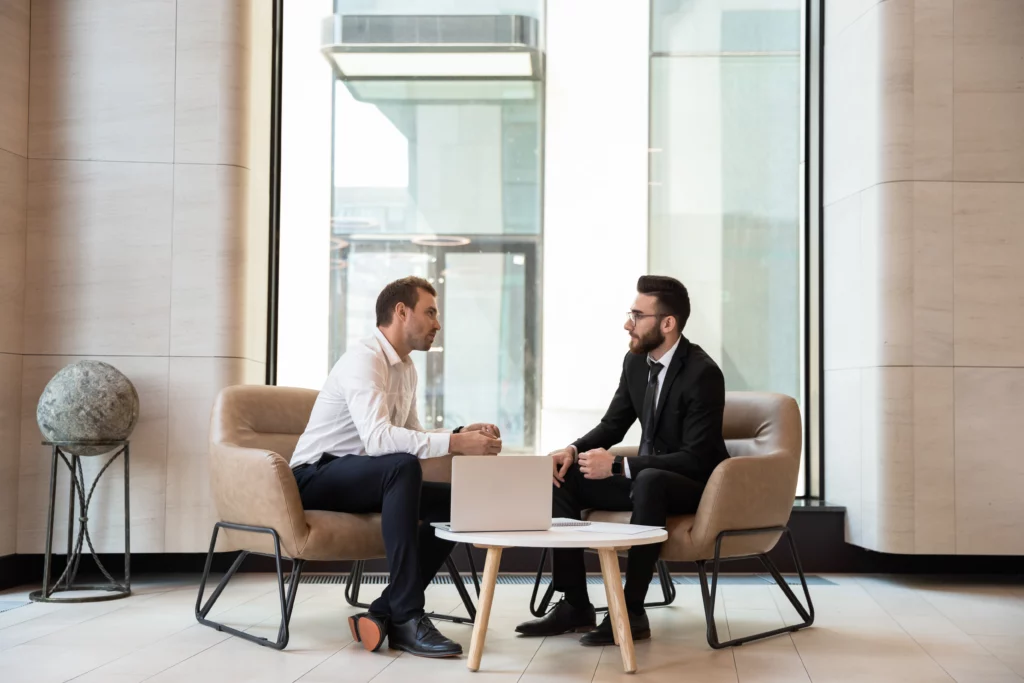 to bsuiness men consulting at a table